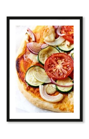 Home made vegetable pizza with zucchini, tomatoes, red onion and mozzarella.  Close-up