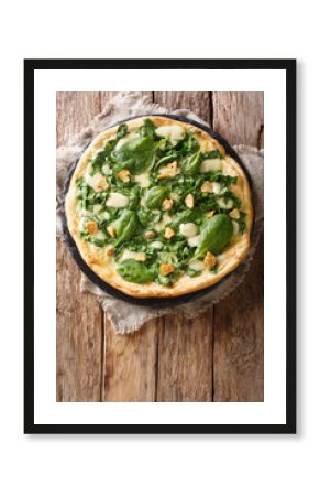 Italian cuisine thin pizza with fresh spinach, garlic and cheese close-up on a board. Vertical top view