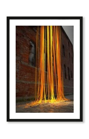 Orange-yellow ribbons cascade down a brick building