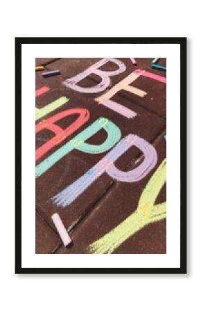 Childlike handprints spelling Happy Birthday on colorful sidewalk