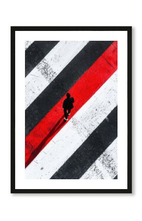 Abstract Urban Crosswalk with Red and Black Stripes and Lone Walker