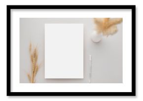 White invitation card mockup with a dried grass and ceramic vase on beige background, Minimal beige workplace composition, flat lay, mockup