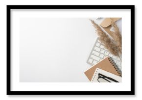 Top view photo of workspace keyboard planners glasses pen envelope letter and reed flowers on isolated white background with empty space
