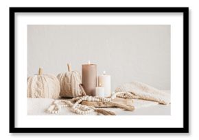 Autumn table decoration. Interior decor for fall holidays with handmade pumpkins and candles. Holiday greeting card