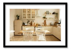 Picture of white cozy kitchen of scandinavian style with counter, oven, furniture and refrigerator, table and chairs in the middle of room. Design project, renting flat advertisement