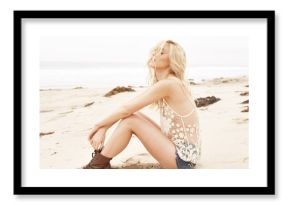 Blonde model on the beach with beautiful hair at sunset