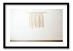 Eco friendly boho style cotton macrame decoration on wooden stick hanging on white wall in light room with minimalist interior
