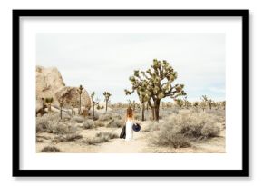 Woman in boho style walking in the Joshua Tree Desert 