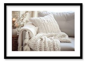 Scandinavian cozy home with white macrame pillows and knit blanket on the sofa displaying detailed interior
