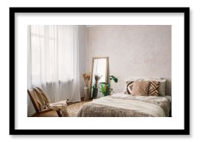 Bohemian bedroom with comfort bed, chair and mirror in room