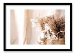 Pampas grass and lunaria are collected in a bouquet for room decor. Bouquet of dried flowers. Floral minimal home interior boho style. Boho style holiday photo zone decor
