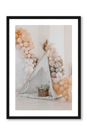 Event decoration in boho style. Beige balls. Children's wigwam.