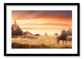 Safari in Serengeti National Park, Tanzania Africa, traveling by car, watching lions and antelopes wildebeest in savannah on background sunset. Adventure and wildlife exploration.