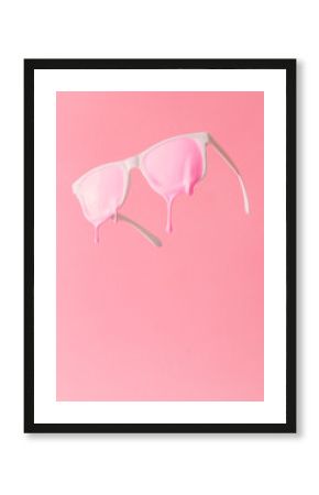 Pink paint dripping out of white painted sunglasses. Creative fashion minimal concept.