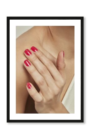 HAND WITH RED NAIL POLISH