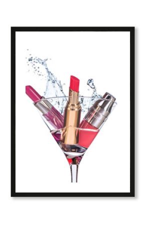 Three types of  moisturizing lipstick stand in the martini glass with big water splash above the glass