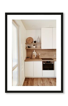 Stylish boho home kitchen interior concept. Wooden shelfs, dishes, utensils, vases, decorations. Cozy white comfortable interior design.