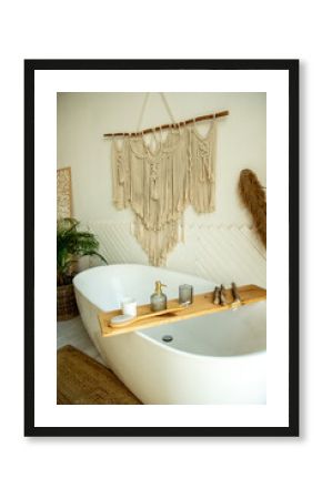 Stylish bathroom interior in boho style. The bathroom has a shelf for brushes, soap and body oils.
