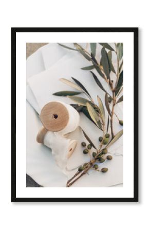 Meditterannean summer wedding still life. Blank cotton paper invitations, olive tree branch and silk chiffon spools in sunlight. Blank invitation cards. Selective focus, blurred background, top view