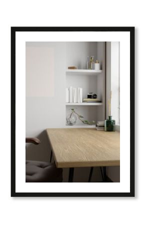 Minimal Scandinavian home workspace with copy space on minimal wood table, blank poster on wall