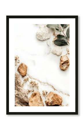 Natural stones and leaves on white marble.  Elevated aesthetic, possible for beauty or wellness products