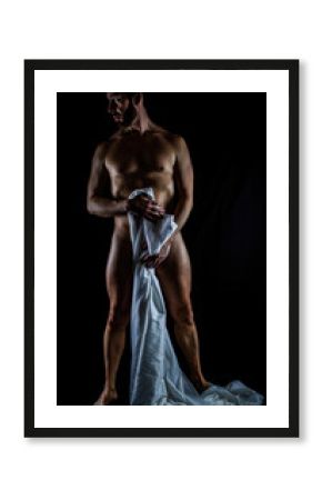 artistic nude male standing pose accenting muscular definition and glistening skin, dual side lighting against black background
