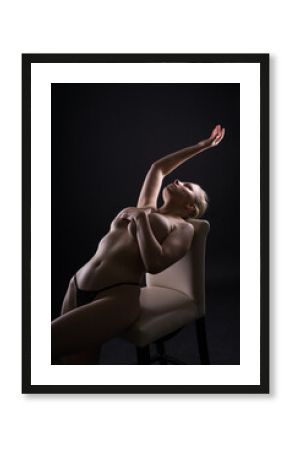 Topless sensual caucasian woman. On black background.