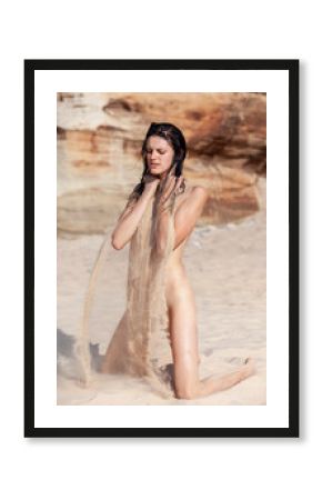  Young fully nude woman relaxing on sea sandy beach