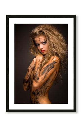 sexy and innocent woman with paint smudge on her naked body
