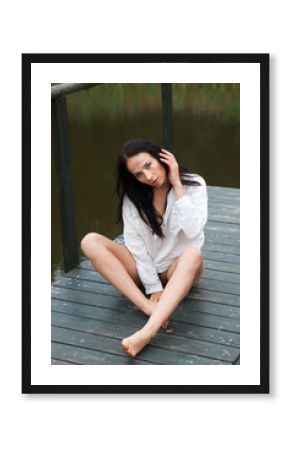 Beautiful young naked woman near a small pond