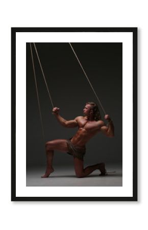 Young naked man, muscular body, bounded with rope