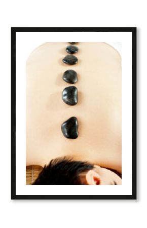 Naked woman getting spa hot stone treatment