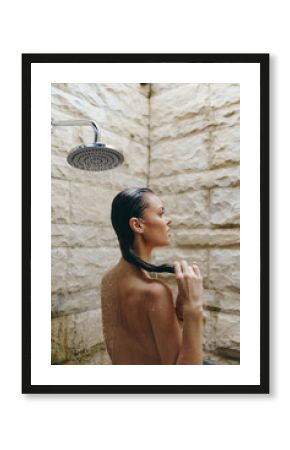 naked woman taking shower in rustic stone bathroom, wet hair, side profile, refreshing morning routine, natural light, wellness moment