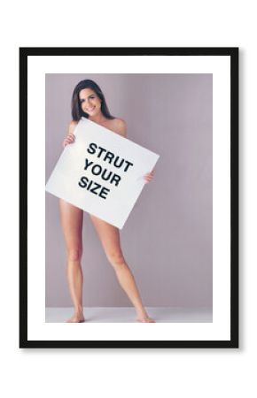 Body positivity, poster and portrait of naked woman in studio with empowerment or motivation sign. Self love, happy and female person with board for inspiration or confidence by gray background.