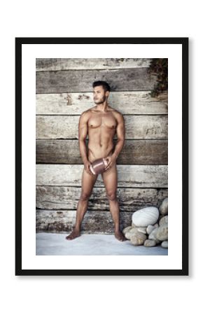 How could masculinity get more masculine. Full length shot of a handsome young man holding a football while posing nude.