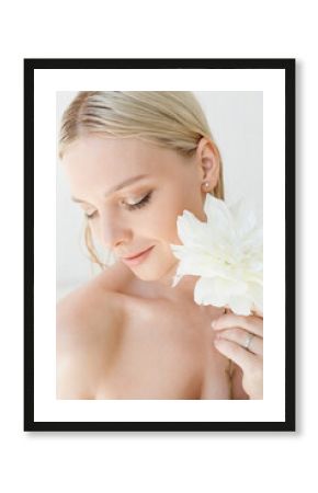 portrait of a young woman holding a flower