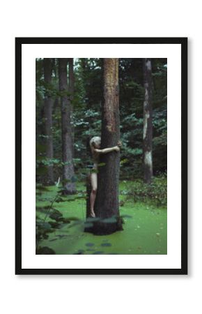 Bare lady hugging large tree in marsh scenic photography. Picture of person with wild forest on background. High quality wallpaper. Photo concept for ads, travel blog, magazine, article