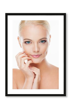 Portrait of a young woman with blonde hair and blue eyes looking at the camera with a white background