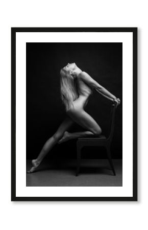 Abstract fine-art portrait. Black and white photo of nude beautiful woman. Female body on black background. 