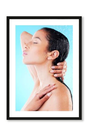 Woman, washing hair or showering in blue studio background for cosmetics, hygiene and wellness, Female person, eyes closed and water cleaning head for grooming, skincare and treatment or bath