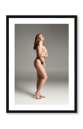 A stunningly beautiful, naked woman showcasing her natural beauty through an artful pose.
