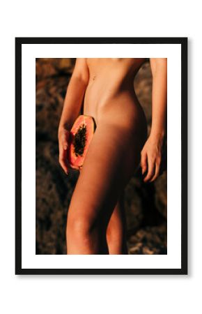 Sensual picture of nude woman's body with papaya