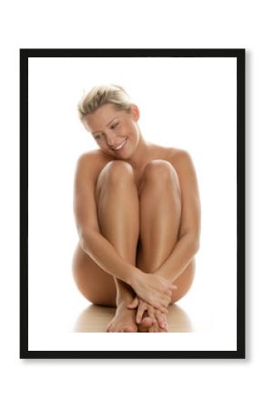 Young naked woman sitting isolated on white background
