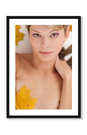 Portrait of attractive nudity woman covering by maple leafs