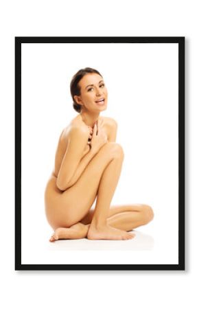 Nude woman sitting and laughing