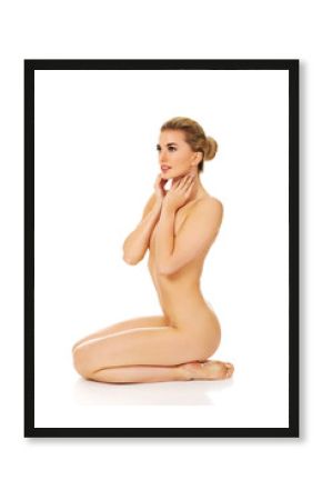 Young naked woman sitting on the floor 