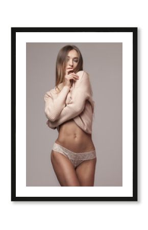 Beautiful sporty woman body. Sexy beautiful woman. Slim tanned lady in beige lingerie.