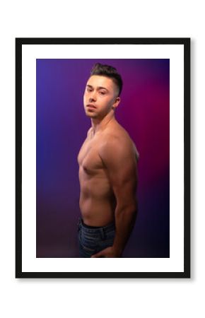 Handsome man posing at the studio without clothes at the torso