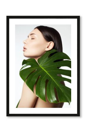 beautiful girl with palm leaves. Beautiful young naked woman