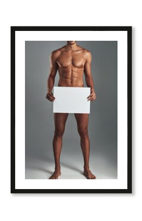 Man, naked and blank board in studio for body positivity, announcement and advertising acceptance of poster. Nude, male person and billboard with muscles for self love, sexuality and gray background